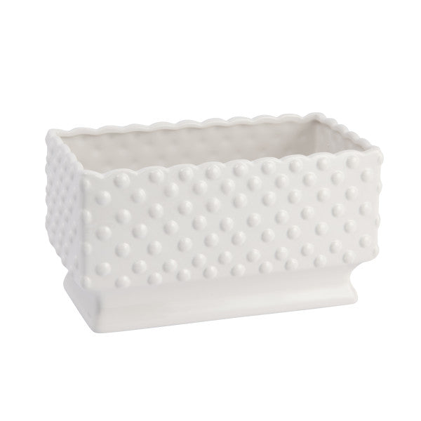 A white ceramic planter with a hobnail texture, scalloped edge, and polka dots.